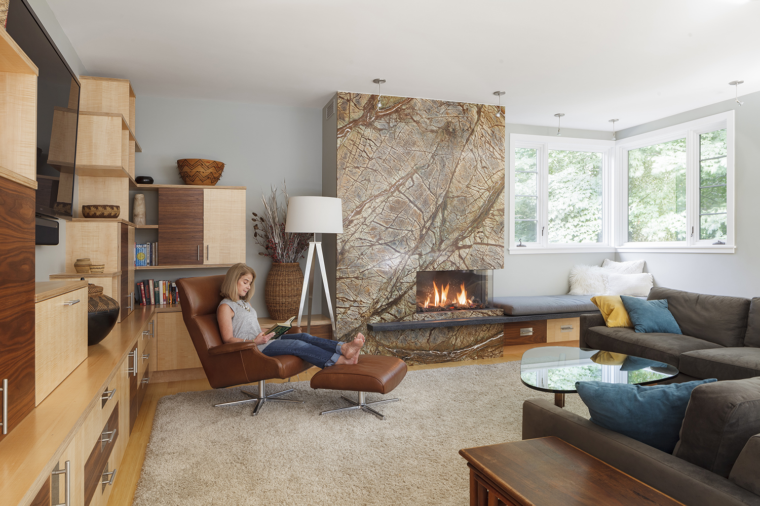 Homeowner, Catherine Riedel, enjoying her living room featuring the Bidore 95 fireplace.