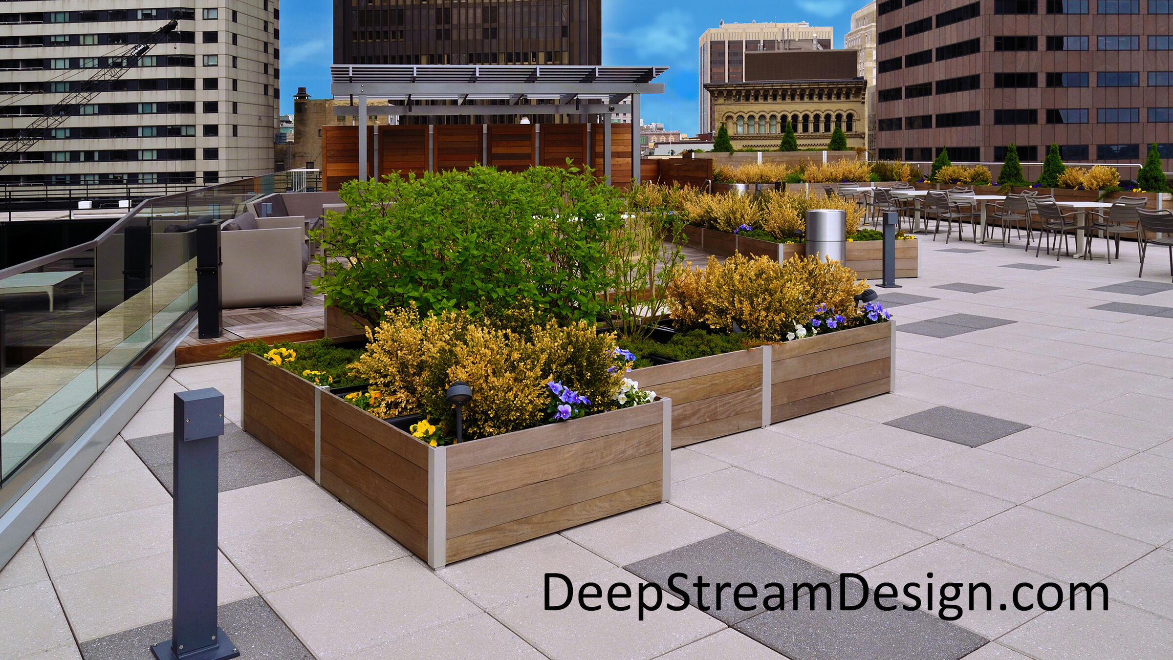 Trademark Mariner anodized aluminum extrusions hold tropical hardwood planks, creating a façade that contains waterproof liners, advanced directed drainage, and drip irrigation systems.