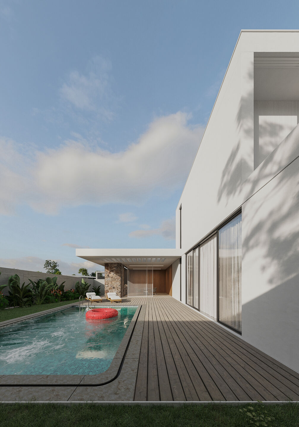 a courtyard with an open-air swimming pool and a green area decorated with local plants.