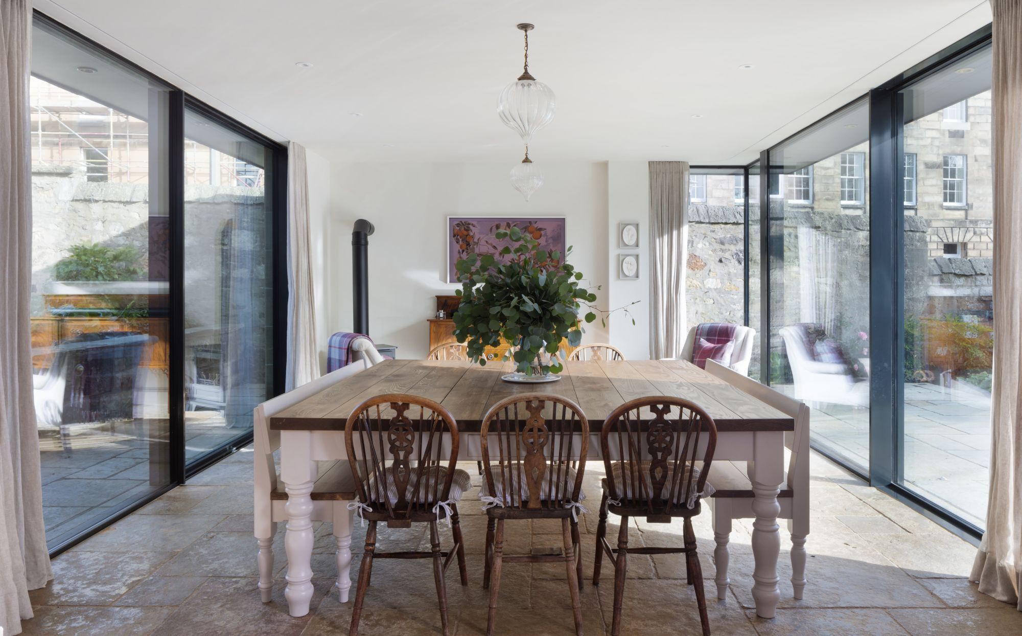 Dual aspect slim framed sliding glass doors to kitchen and dining space