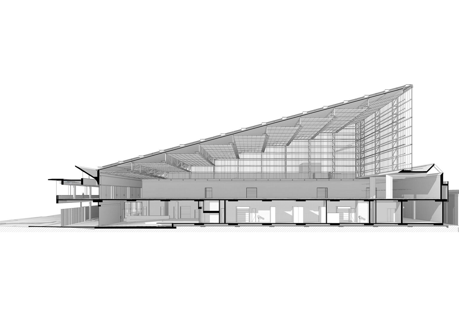 The façade with translucent building elements sits on a massive concrete structure.