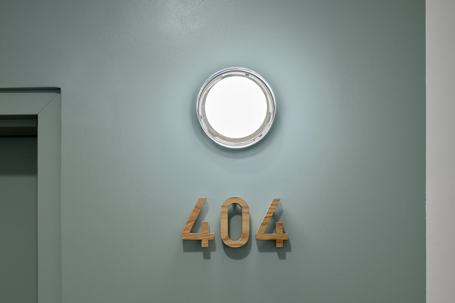 Small but important details, like wood apartment numbers and wood coat hooks near unit entrances communicate an elevated quality of craft while also increasing the functionality of the space.