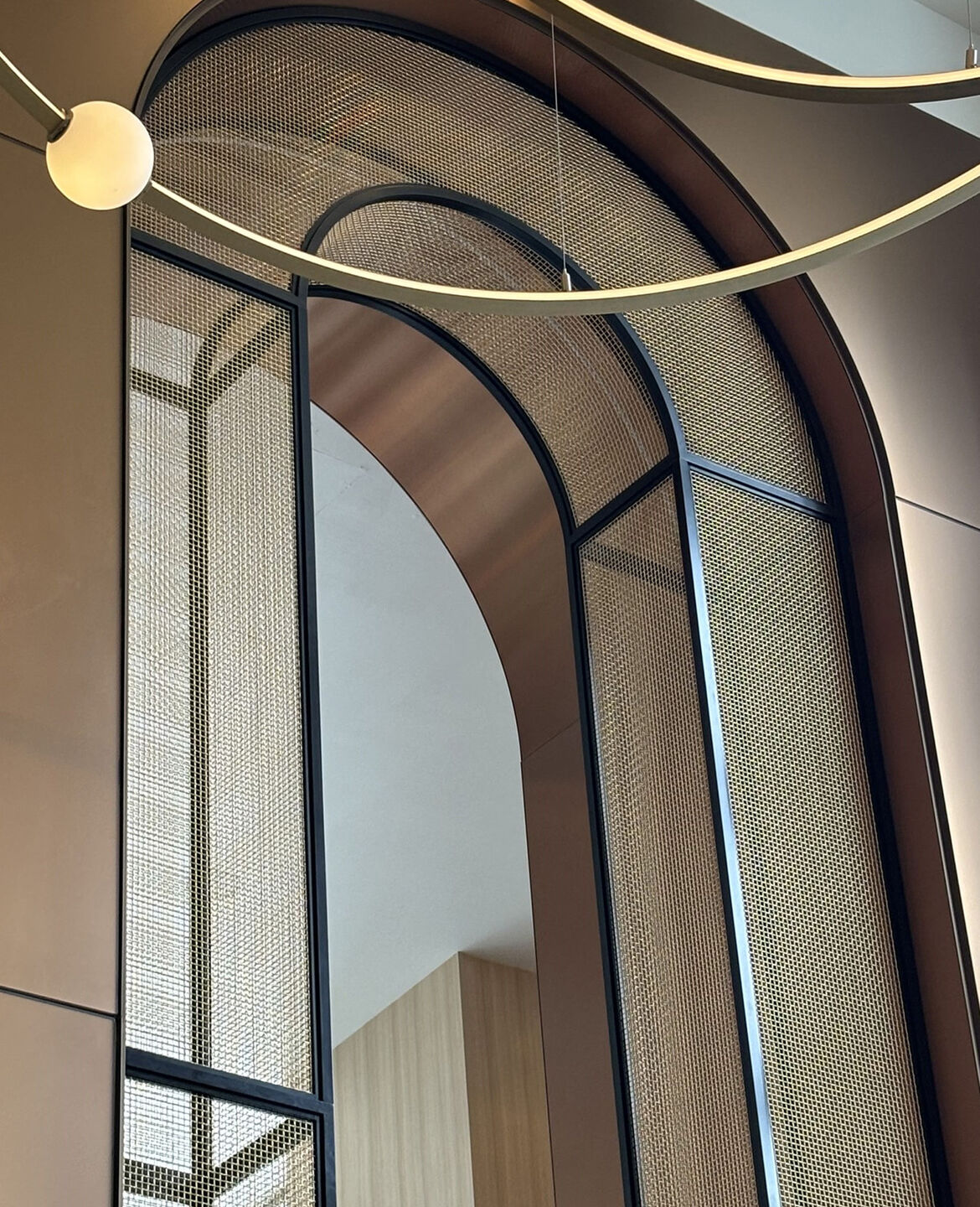 Detail of the arch way framed in bronze decorative woven wire mesh at Omni San Diego Hotel