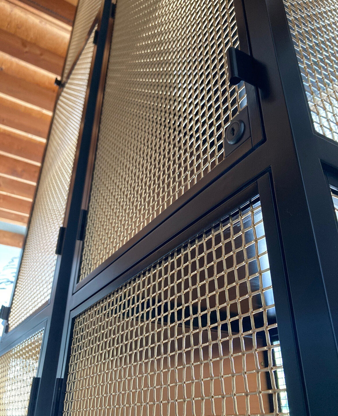 Curved bronze mesh archway designed and fabricated by Desposito Designs for the Ace Porter bar in the Omni San Diego
