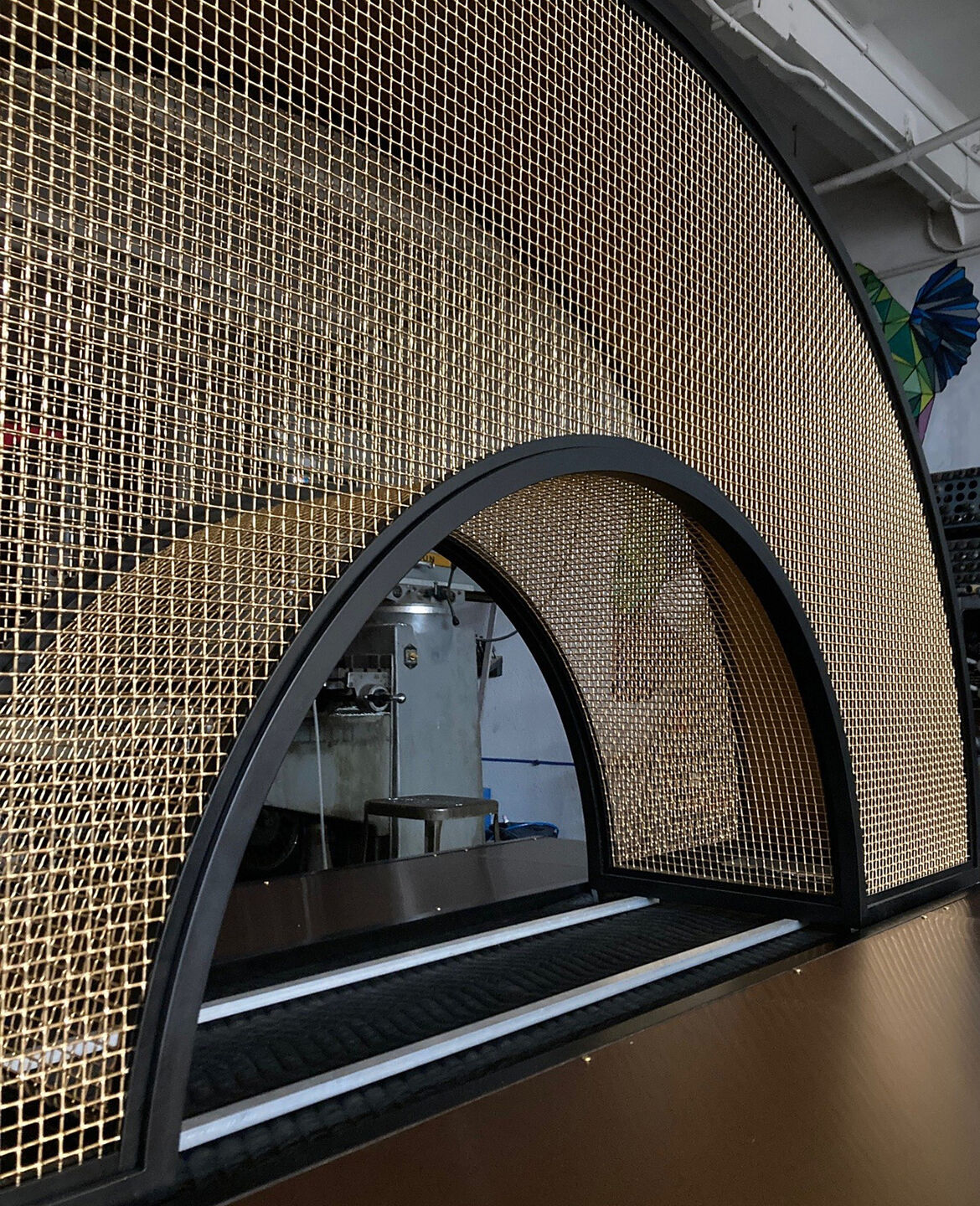 Curved bronze mesh archway designed and fabricated by Desposito Designs for the Ace Porter bar in the Omni San Diego