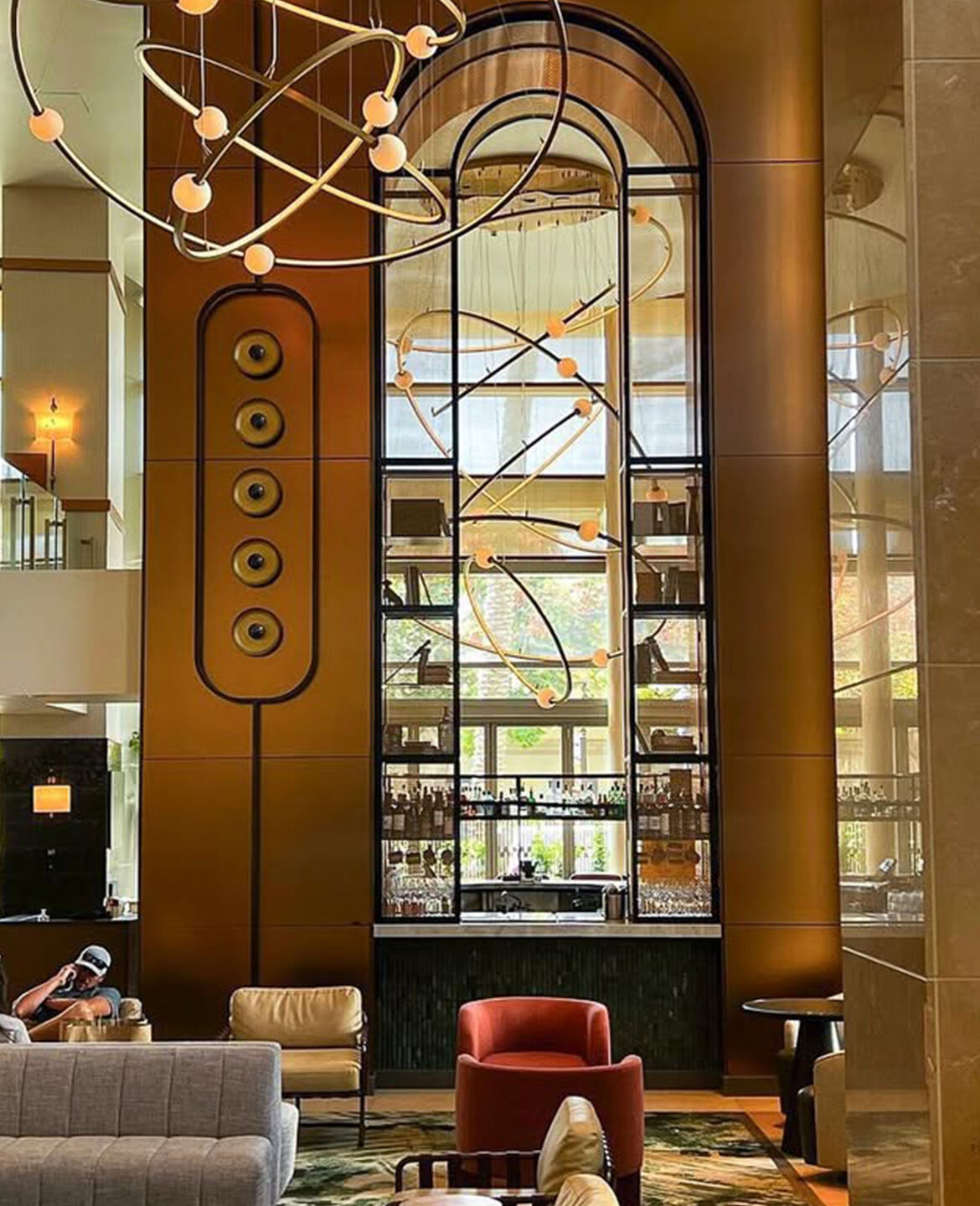 Bronze arch way framed in decorative woven wire mesh at Omni San Diego Hotel