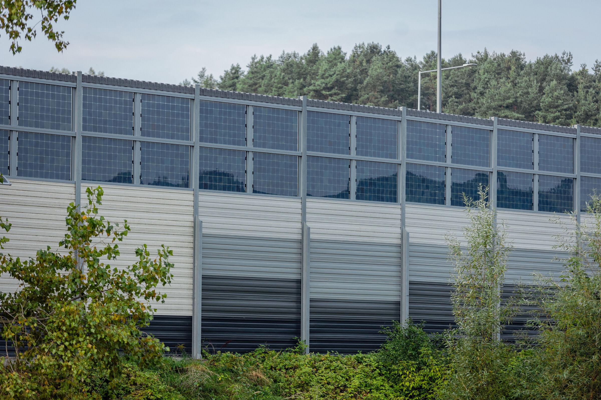 sound barrier with integrated solar panels near highway in Vilnius, Lithuania