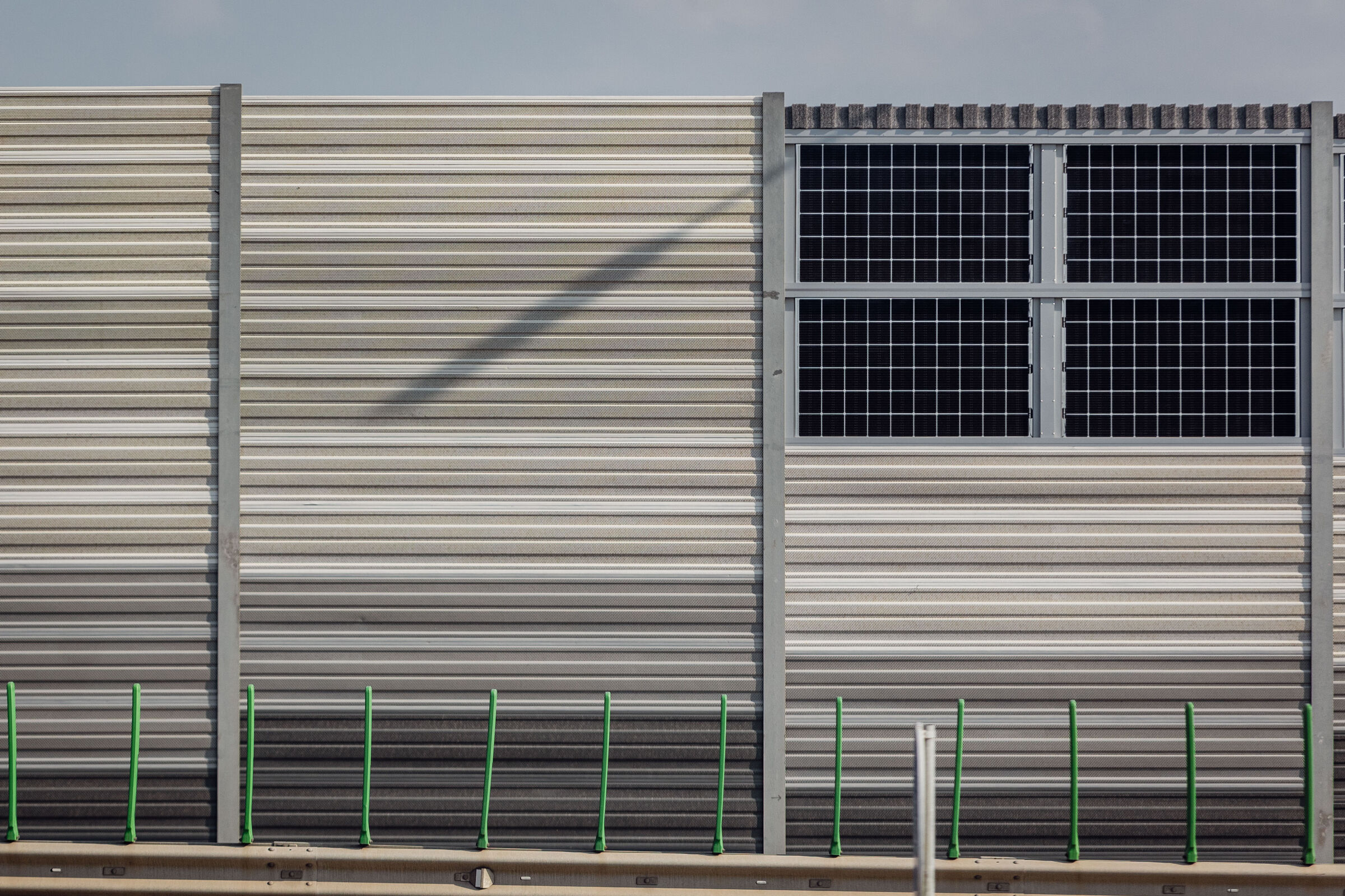 sound barrier with integrated solar panels near highway in Vilnius, Lithuania