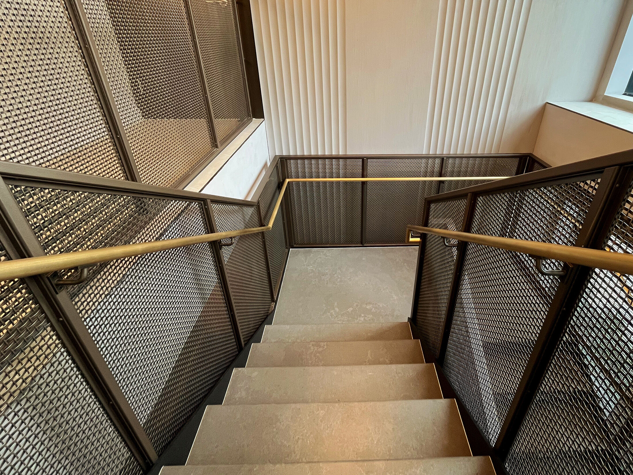 Step into a space where woven wire mesh redefines stairwell design. This New York project blends openness, precision, and bold finishes to create a striking centerpiece for contemporary interiors.