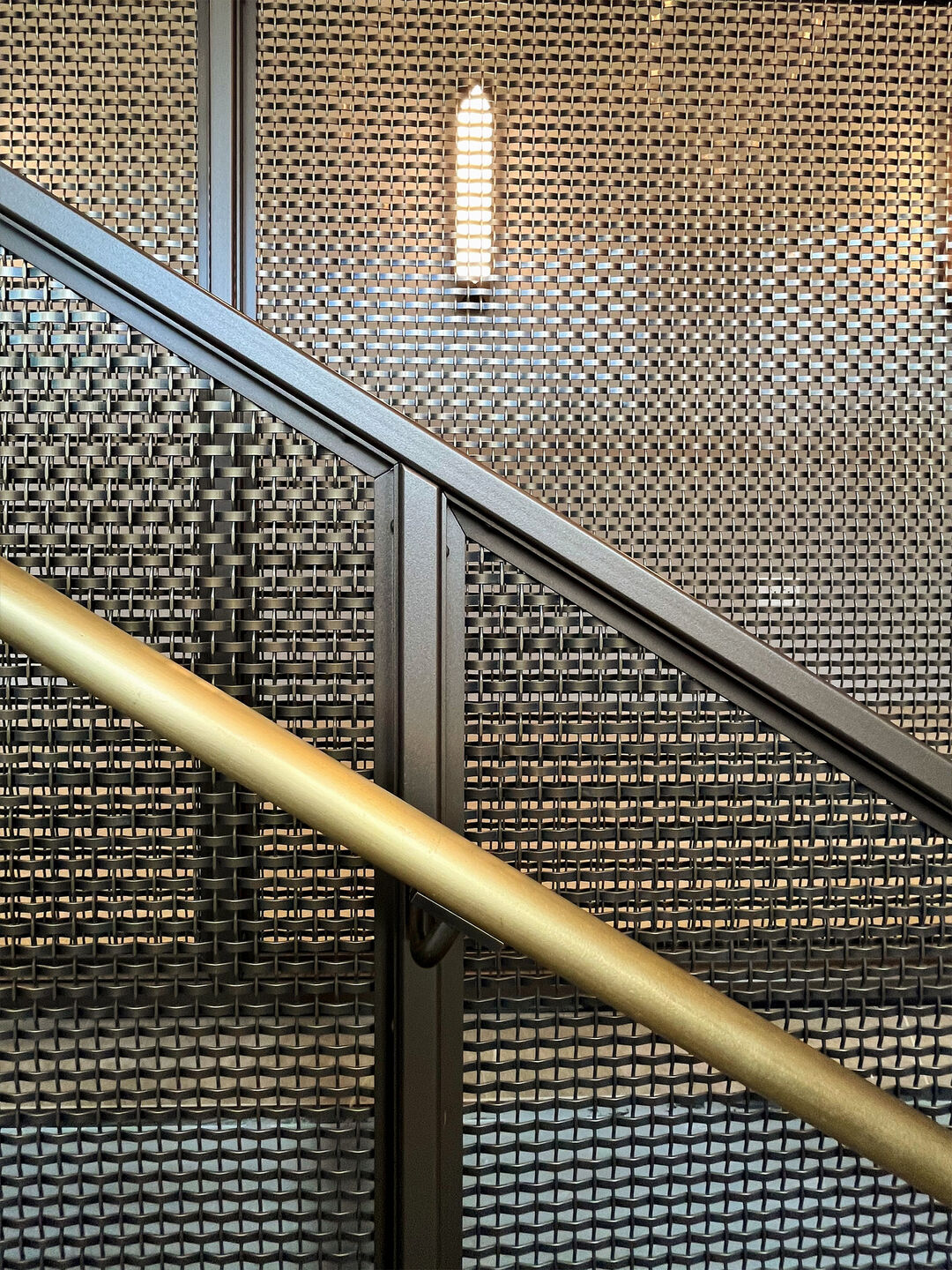 This New York project highlights the beauty and functionality of woven wire mesh in stairwell handrails. This design offers durability, light flow, and a clean aesthetic for upscale commercial spaces.