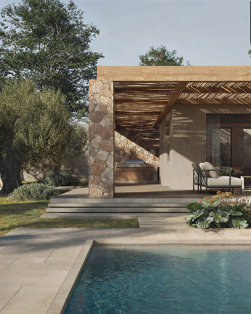 Pergola-shaded outdoor living space with natural stone walls and timber structure, opening directly toward the pool and surrounding Mediterranean planting.