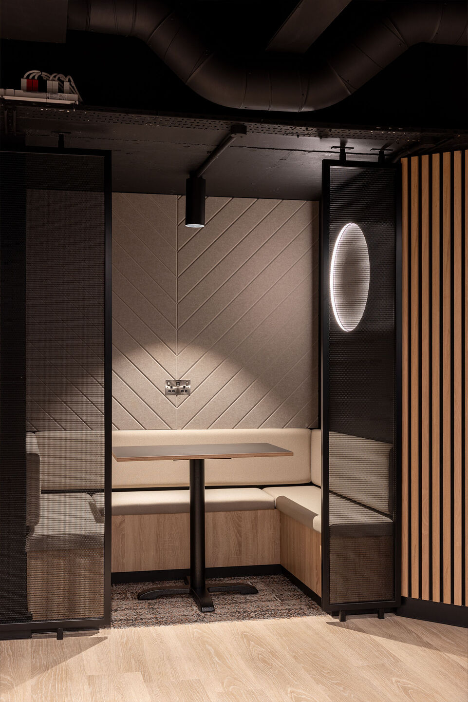 Woven wire mesh space dividers in Banker LPZ-71 create semi‑private seating booths at 58 Mosley Street, adding to the collaborative workplace atmosphere.