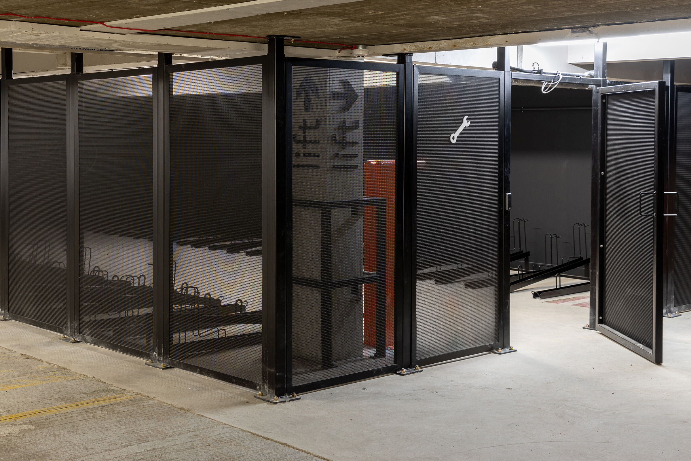 The secure bike storage area uses durable LPZ-71 woven wire mesh panels to provide visibility, ventilation, and long‑lasting protection.