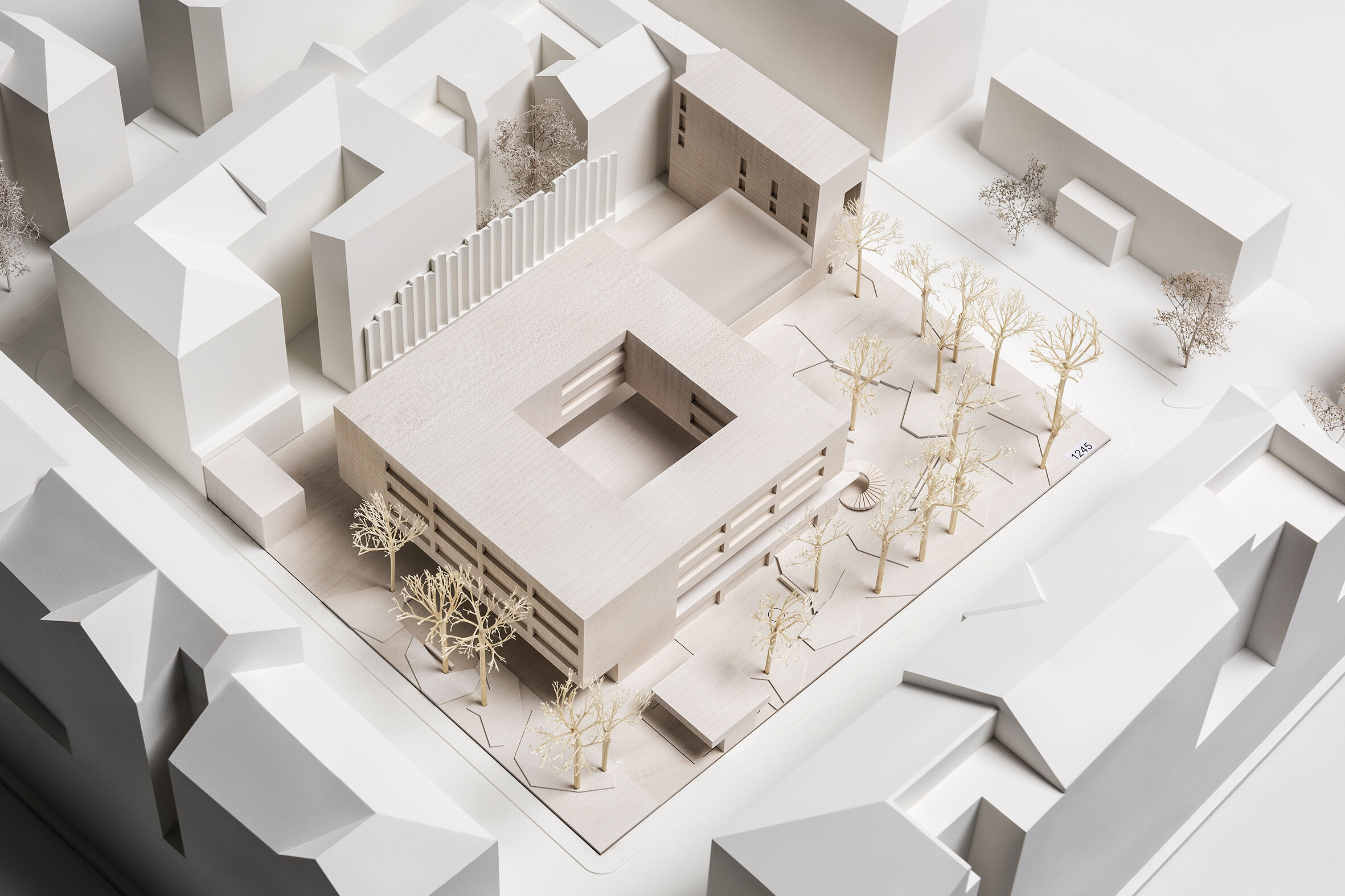 The new structure is recessed from the defined building lines within the plot.