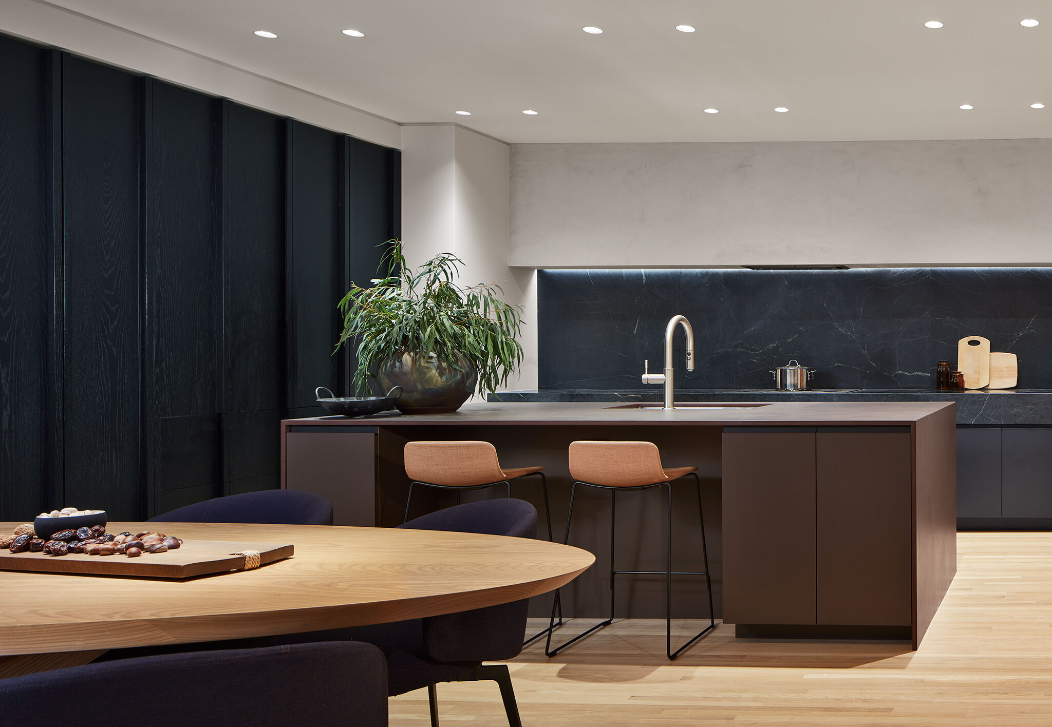 Black-stained oak conceals refrigerators.