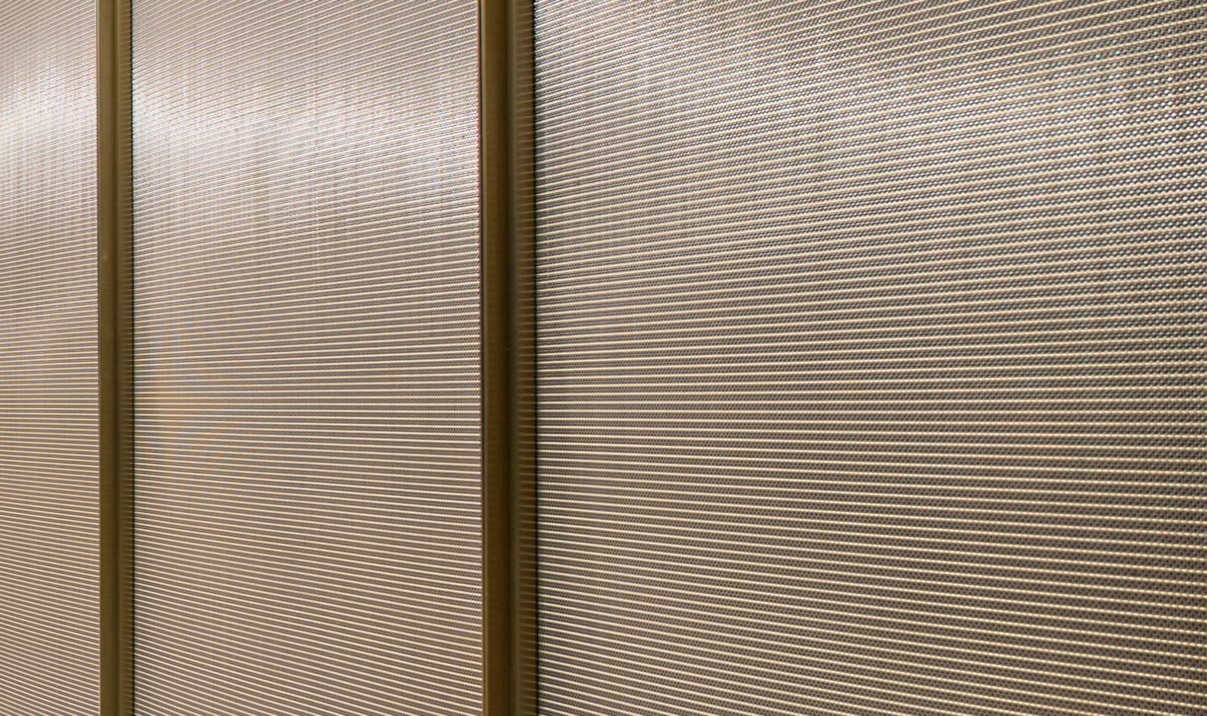 Decorative woven wire mesh IPZ-25 installed in corporate interior design as a space divider.