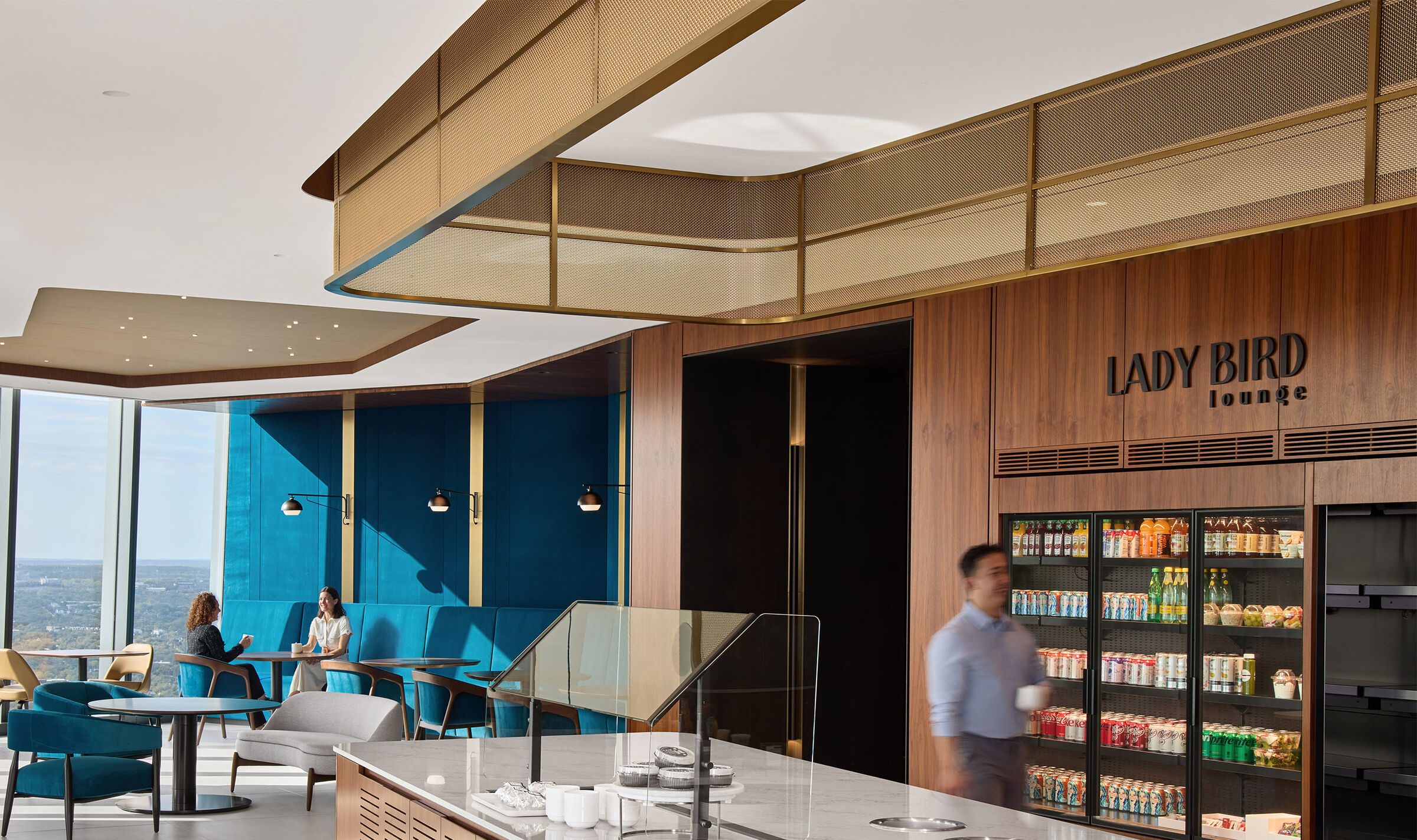 Decorative woven wire mesh installed in corporate interior design as a gantry over a bar