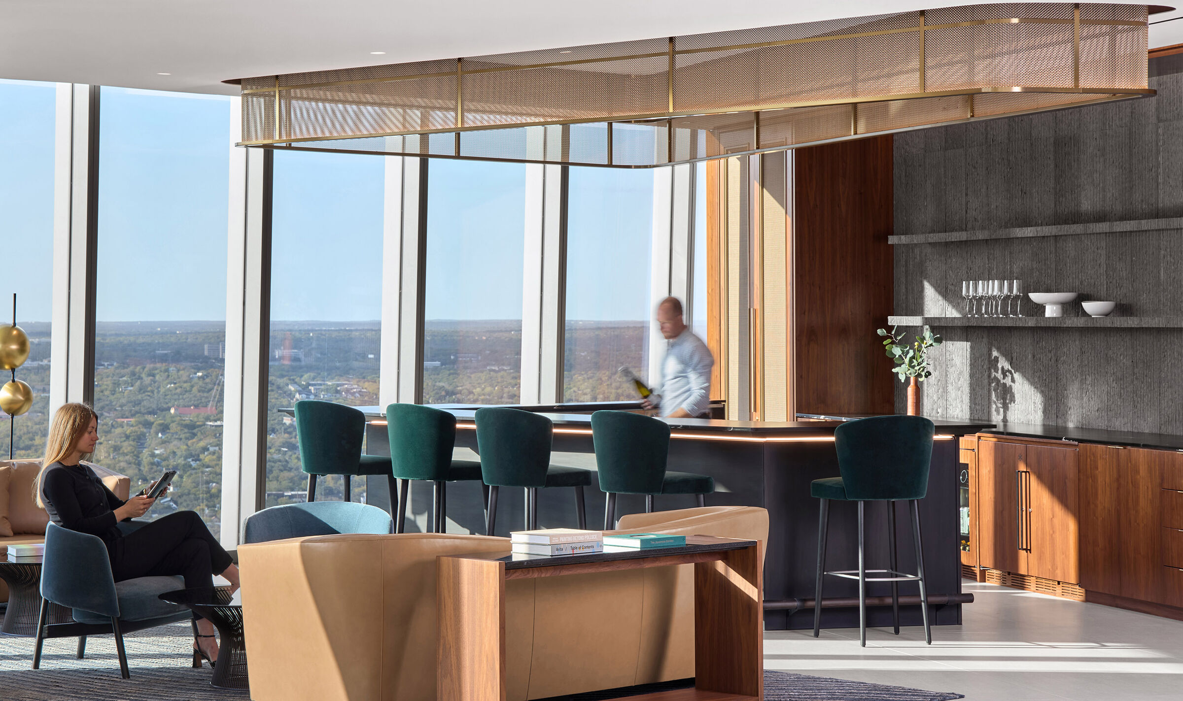 Decorative woven wire mesh installed in corporate interior design as a gantry over a bar