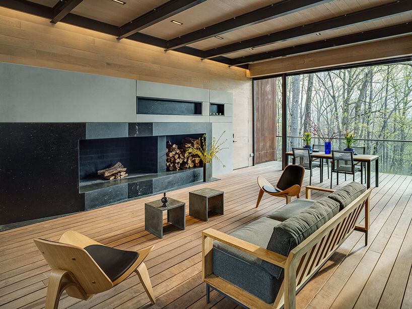 Inspired by nearby boulders, the soapstone-clad fireplace anchors the interior with a natural, sculptural presence.