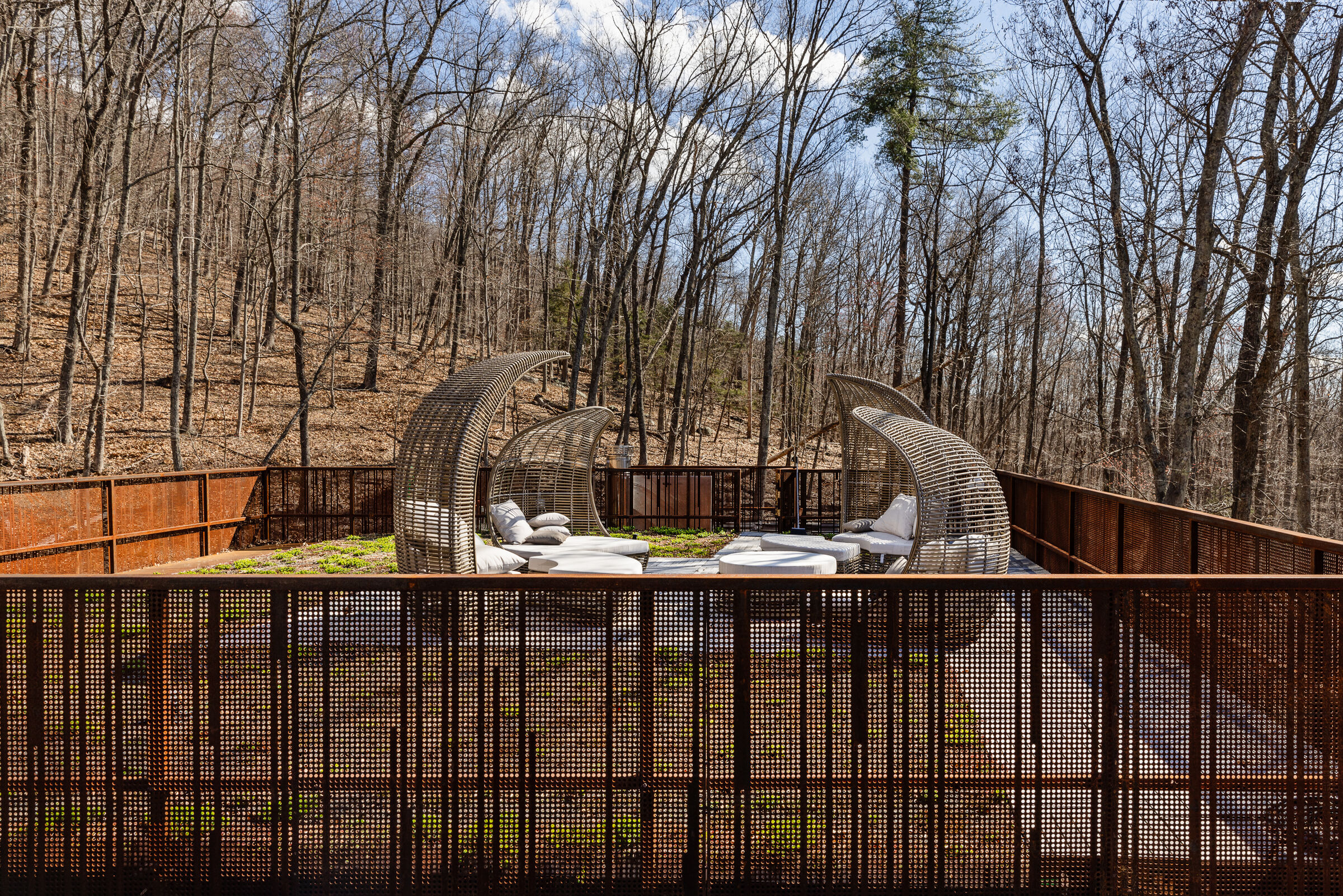 A rooftop green roof sits high above the ravine, allowing inhabitants to fully experience the site's dramatic verticality and layered relationship to the landscape.
