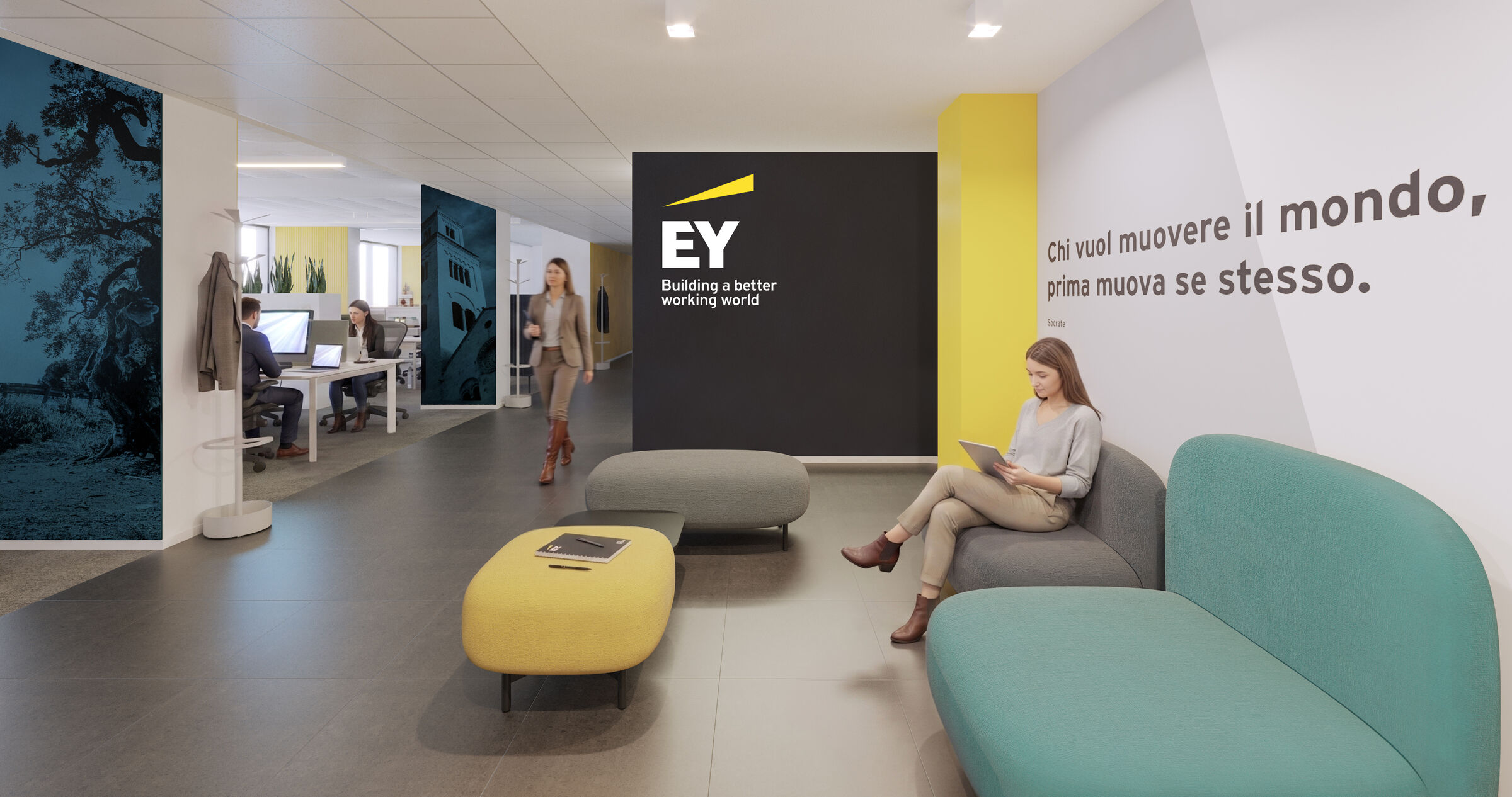 A shared lounge area next to the open-plan space on the first floor: the EY-branded wall separates the reception area from the workstations.
