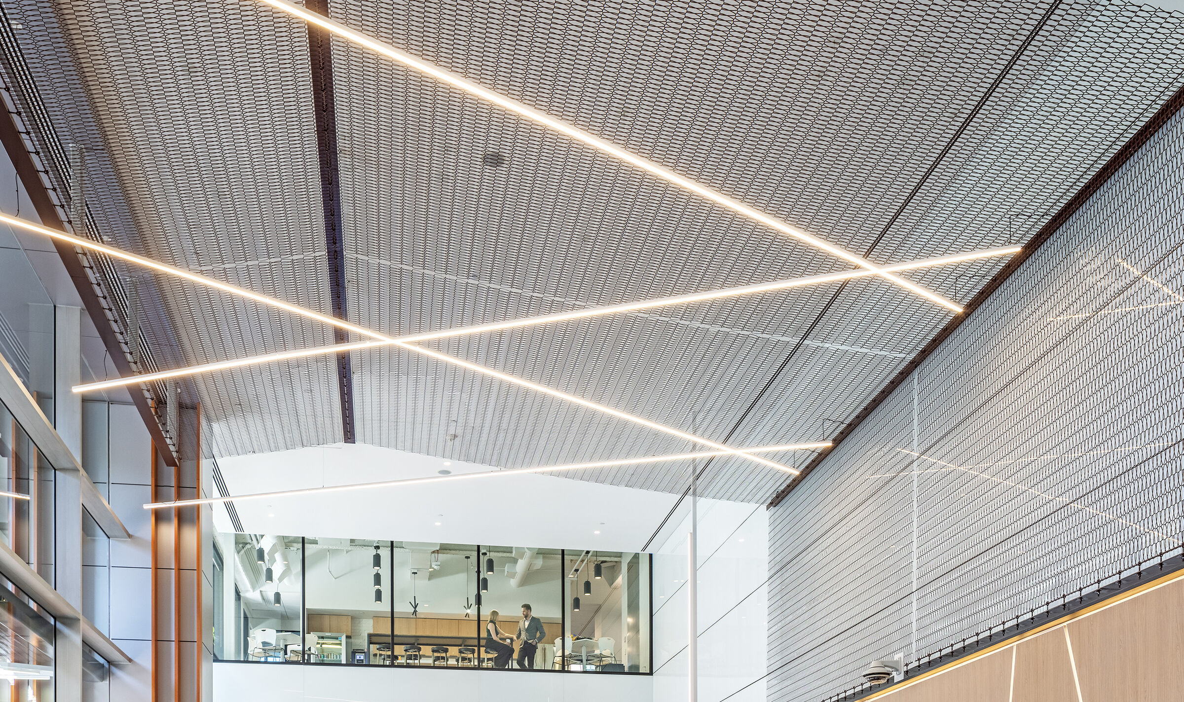 Dune 40100 flexible wire mesh continues the textured design element  from the exterior facade into the welcoming space of the lobby
