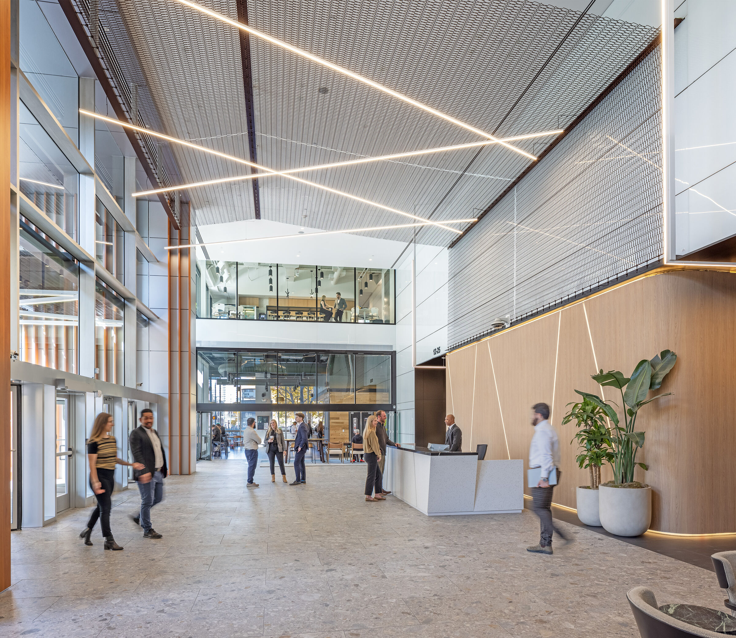Dune 40100 flexible wire mesh continues the textured design element  from the exterior facade into the welcoming space of the lobby