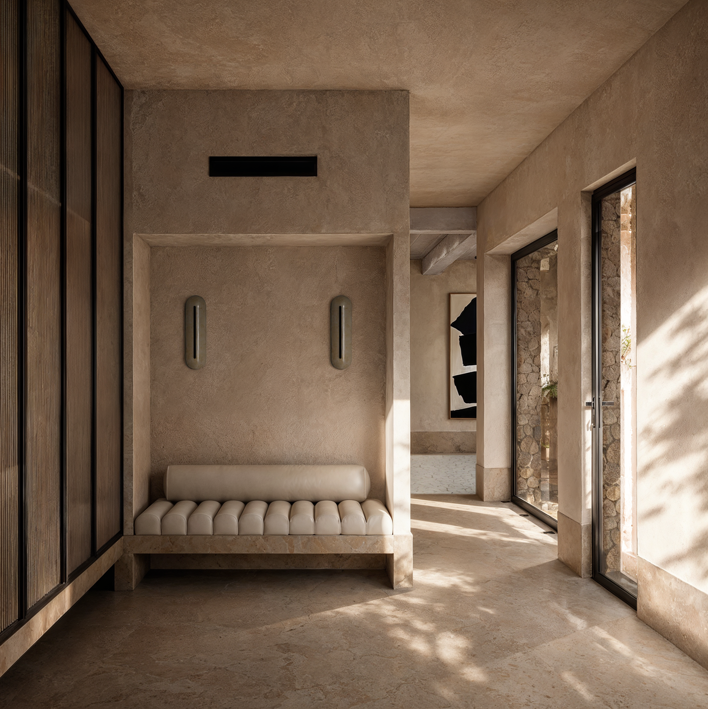 A carefully composed seating area connects with the surrounding interior spaces, where natural daylight and warm materials reinforce the residence's calm architectural character.