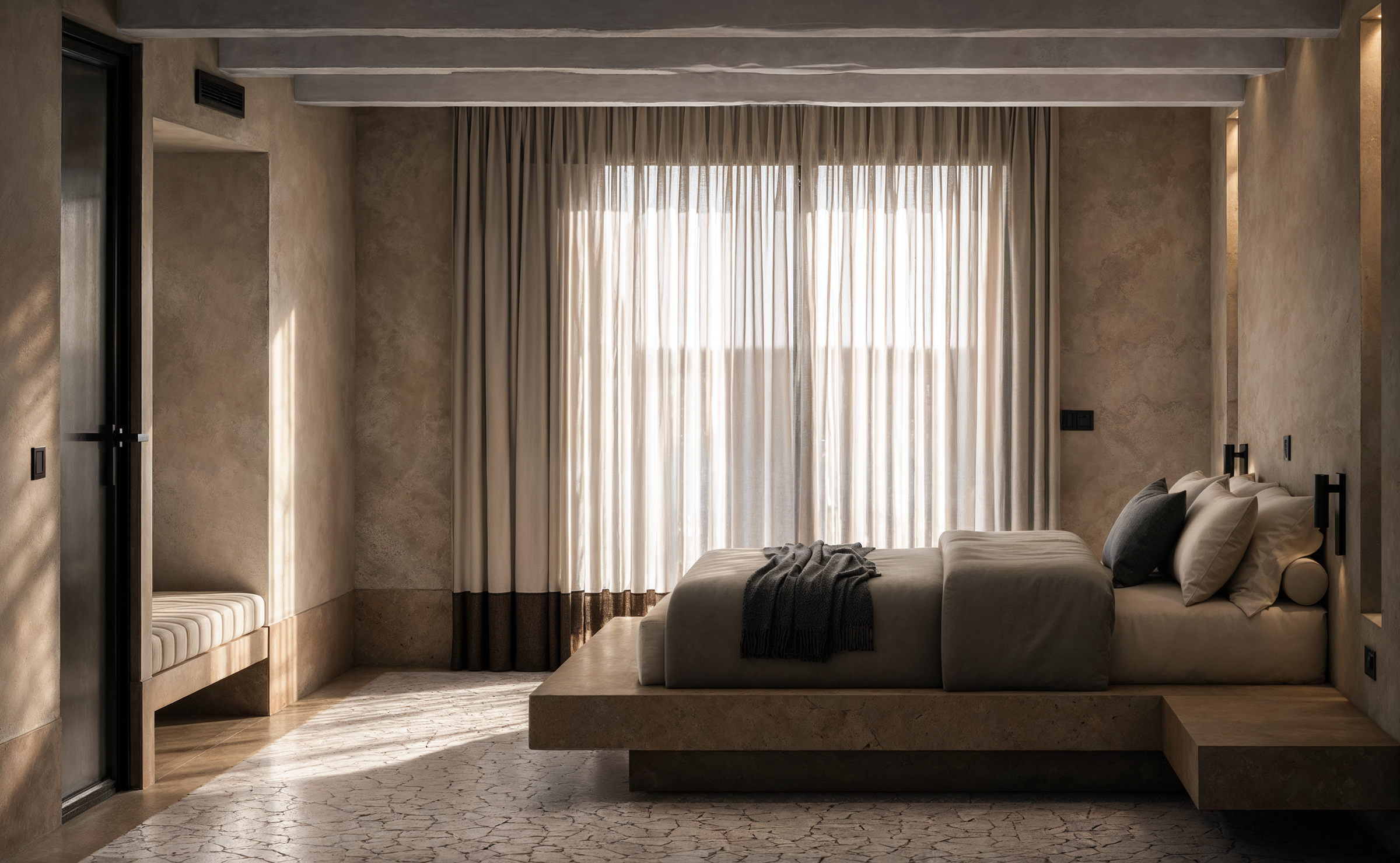 Soft natural light filters through full-height curtains, highlighting tactile plaster surfaces, exposed timber beams, and the bedroom's restrained material palette.