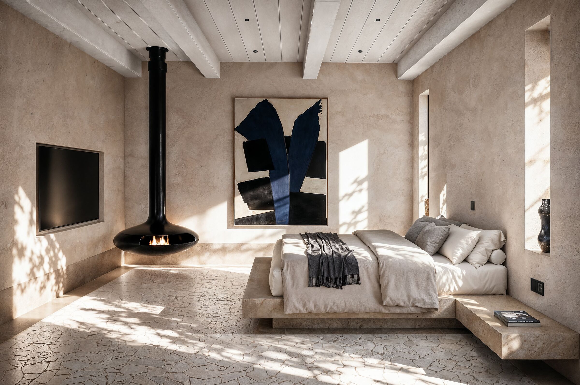 A suspended fireplace introduces a sculptural focal point within the bedroom suite, complemented by traditional ceiling beams, natural finishes, and carefully framed daylight.