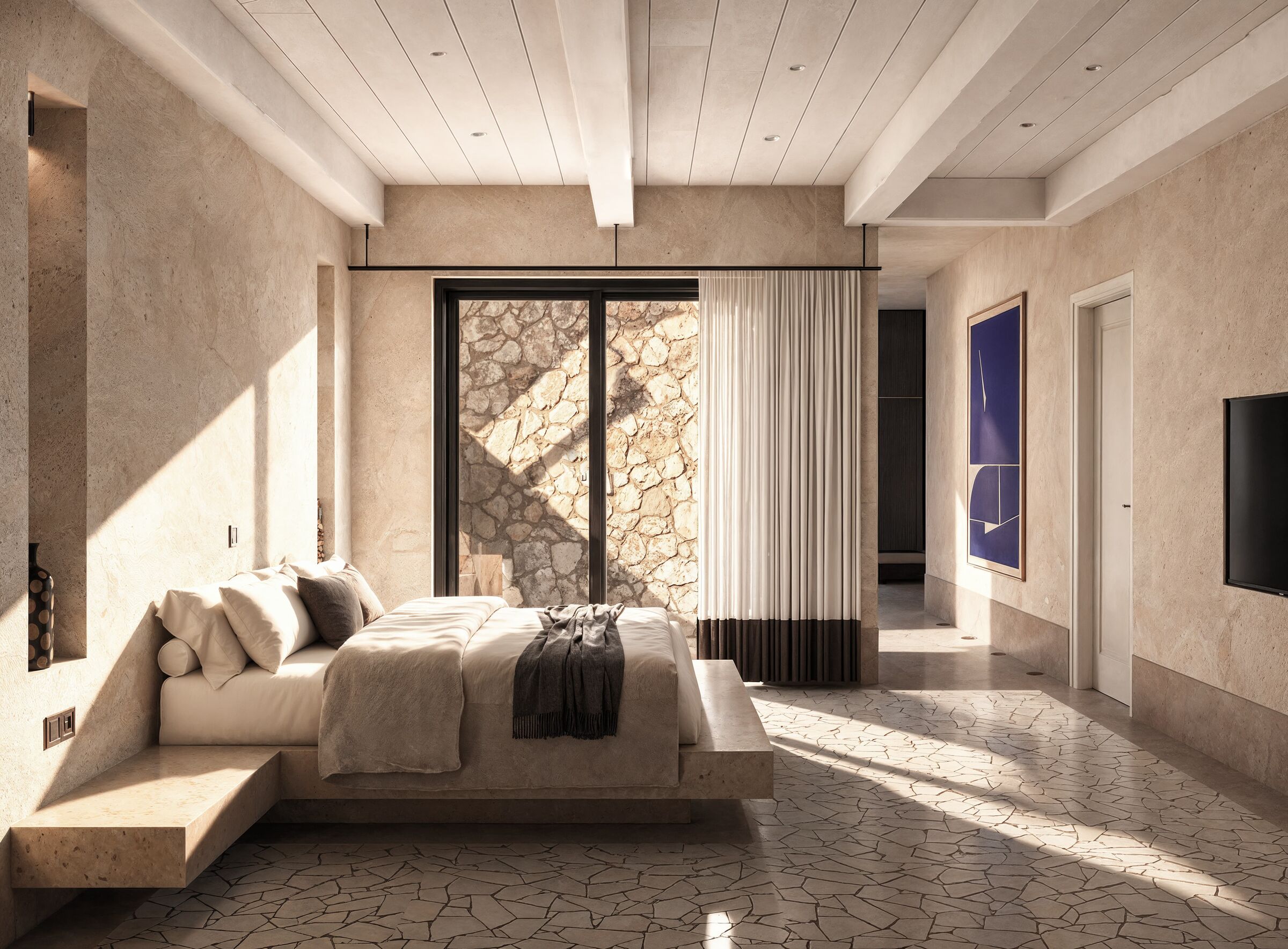 Traditional roof construction, natural wall textures, and contemporary furnishings come together in a bedroom that reflects the distinctive architectural identity of Karpathos.