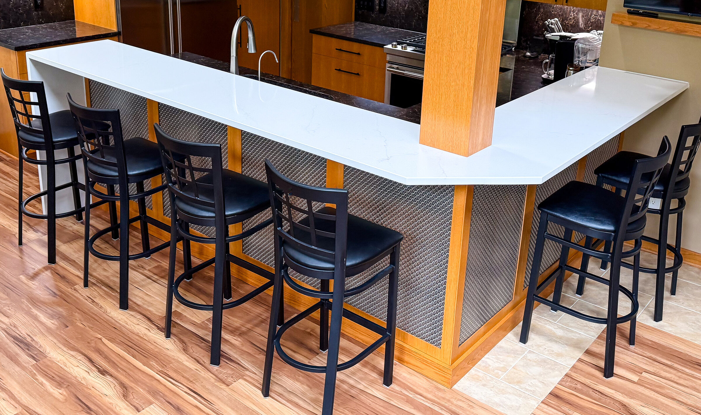This home bar remodel highlights Banker Wire's M33-2 woven wire mesh, a decorative basket weave pattern that enhances the space with depth, texture, and timeless style.