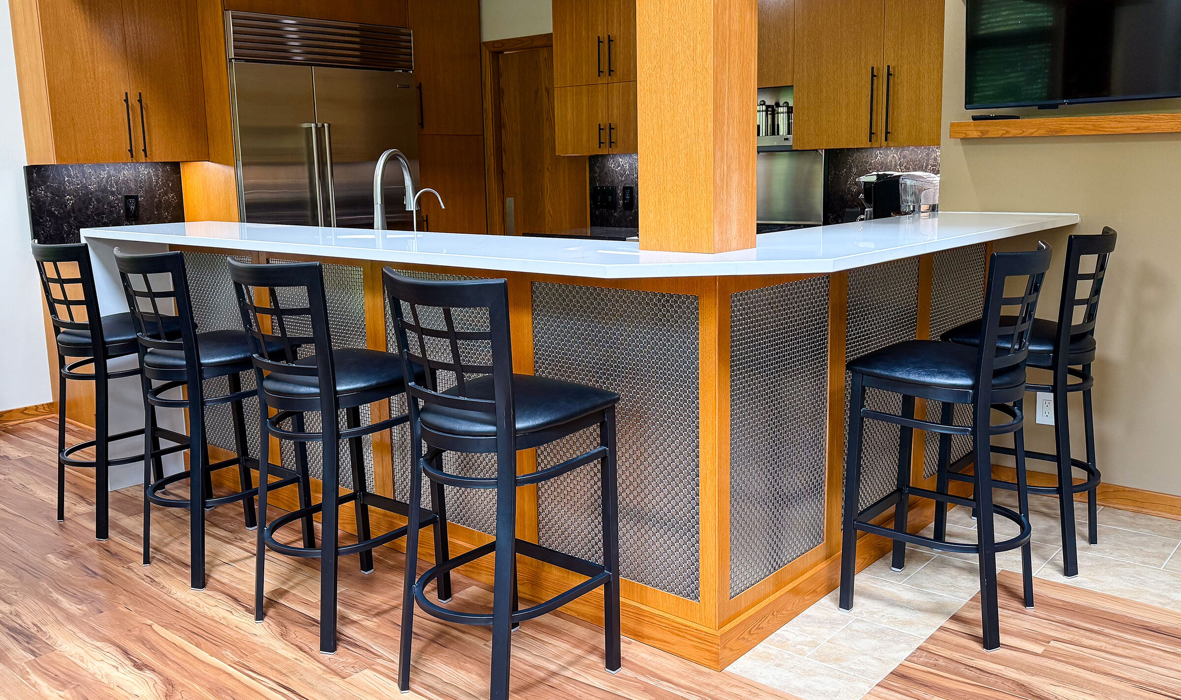 Discover how Banker Wire's M33-2 woven wire mesh adds texture, depth, and sophistication to this custom home bar remodel, creating a striking architectural focal point.
