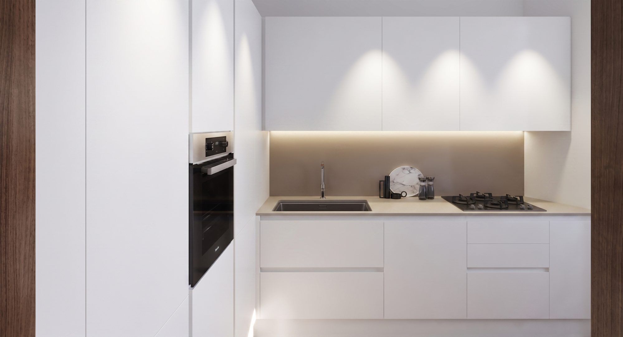 The kitchen wall seen head-on: column oven, sink, hob and LED lighting beneath the wall units.