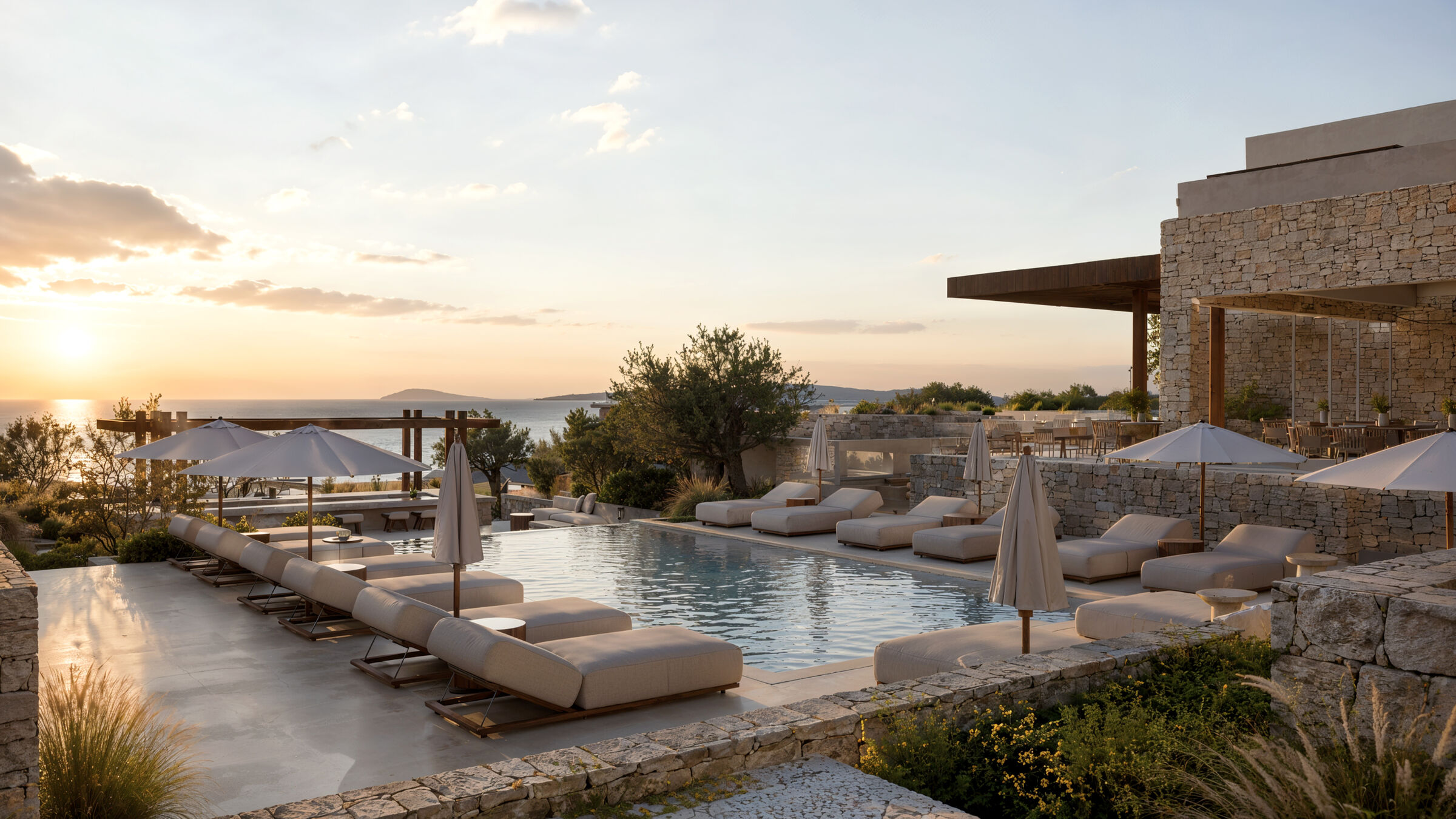 Central pool overlooking the sea at sunset.