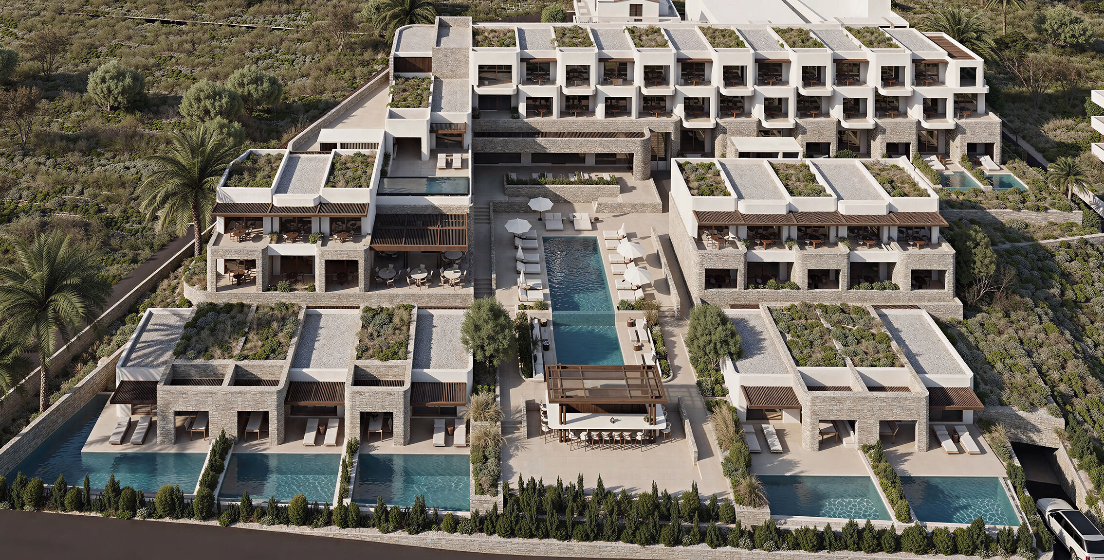 Aerial view revealing the central pool axis and the terraced arrangement of the complex.
