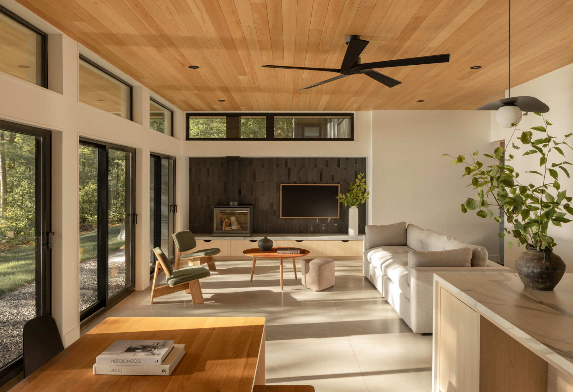 Kitchen, dining, and living areas organized as one shared room on the lake-facing side of the house.
