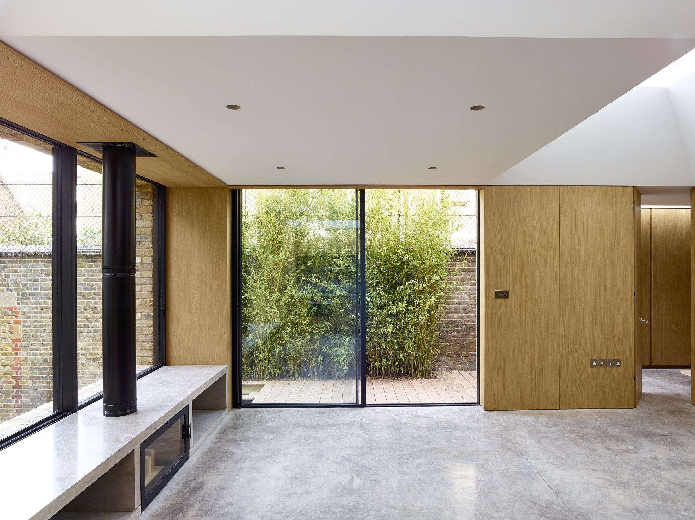 Minimal architectural glazing creates a light-filled entrance with views through to the garden.