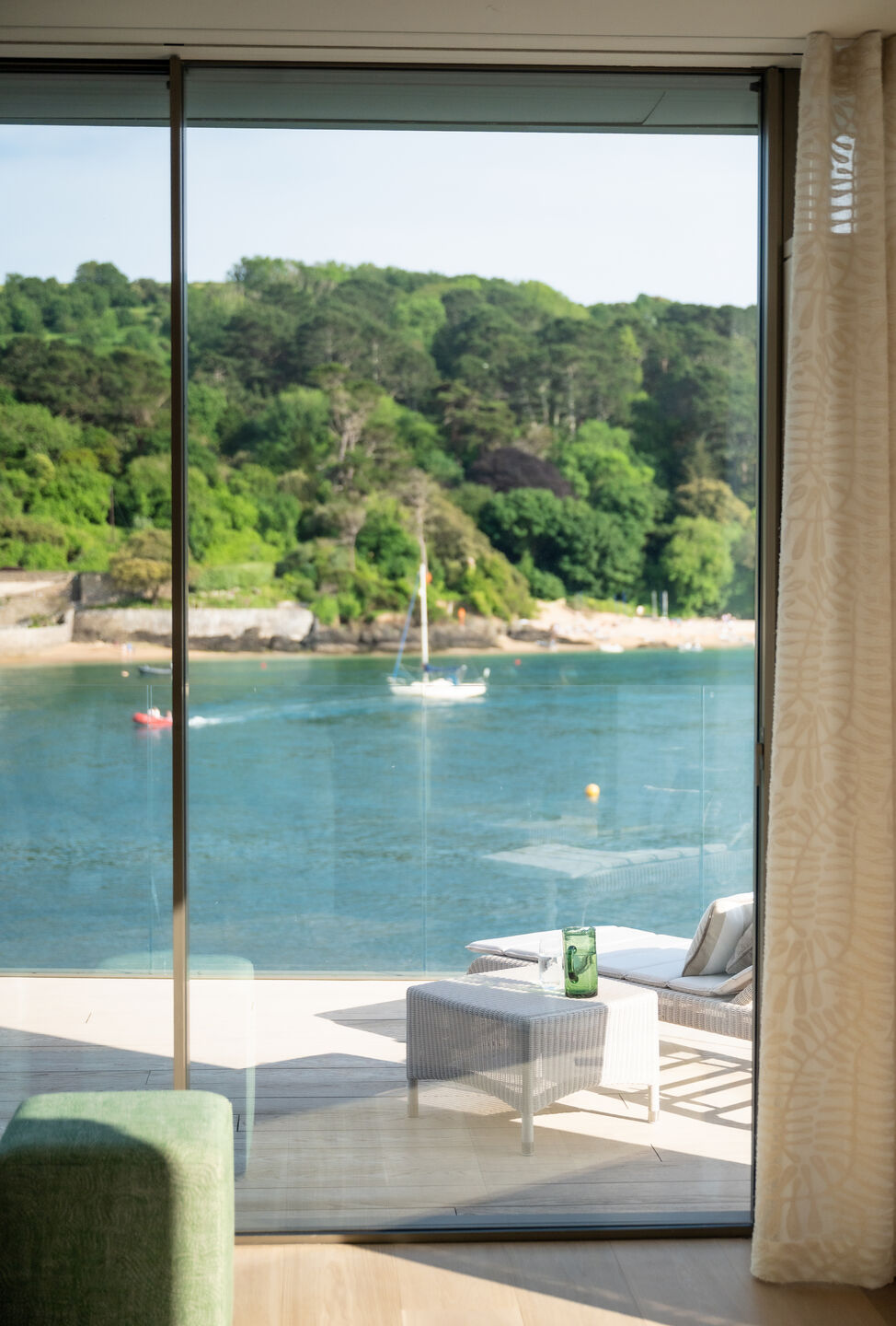 Large-format glazing at Orestone End providing uninterrupted views across the coastal landscape