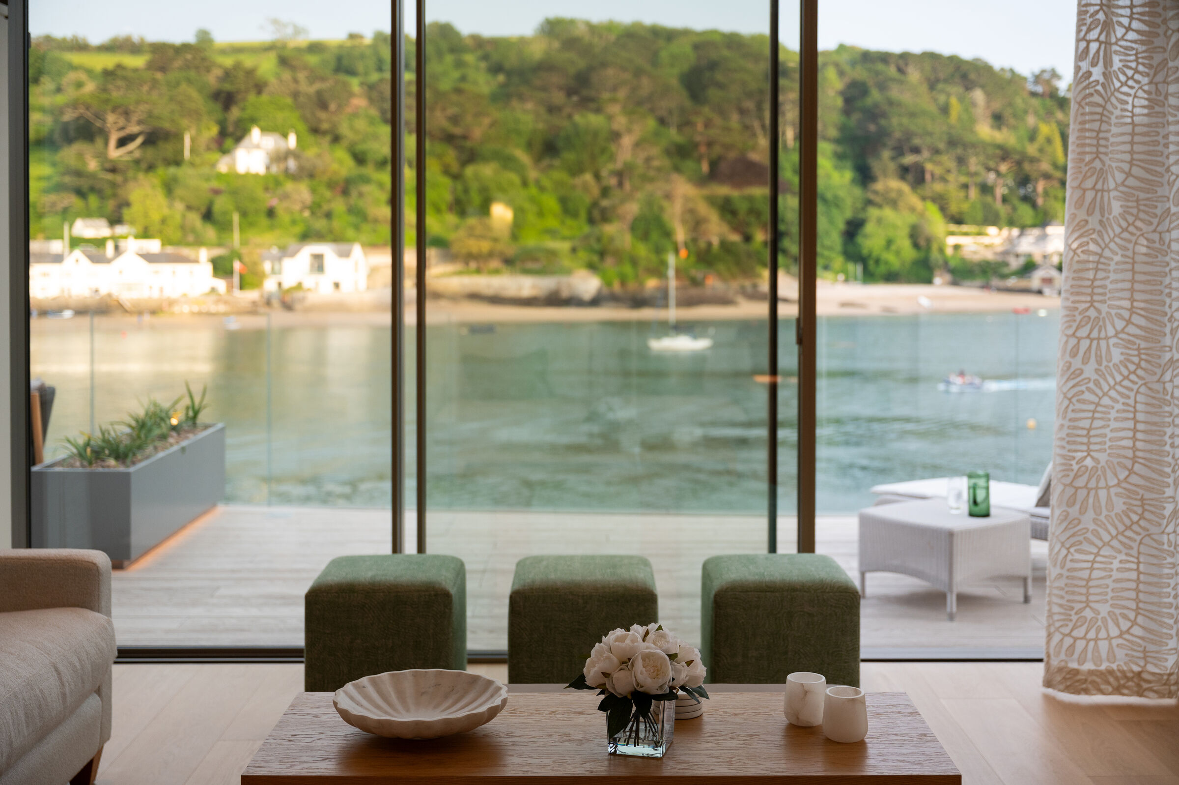 Contemporary living space at Orestone End with floor-to-ceiling glazing overlooking the sea