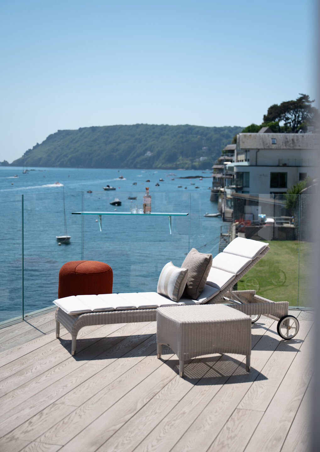 Outdoor terrace at Orestone End with large sliding glass doors overlooking the Salcombe coastline