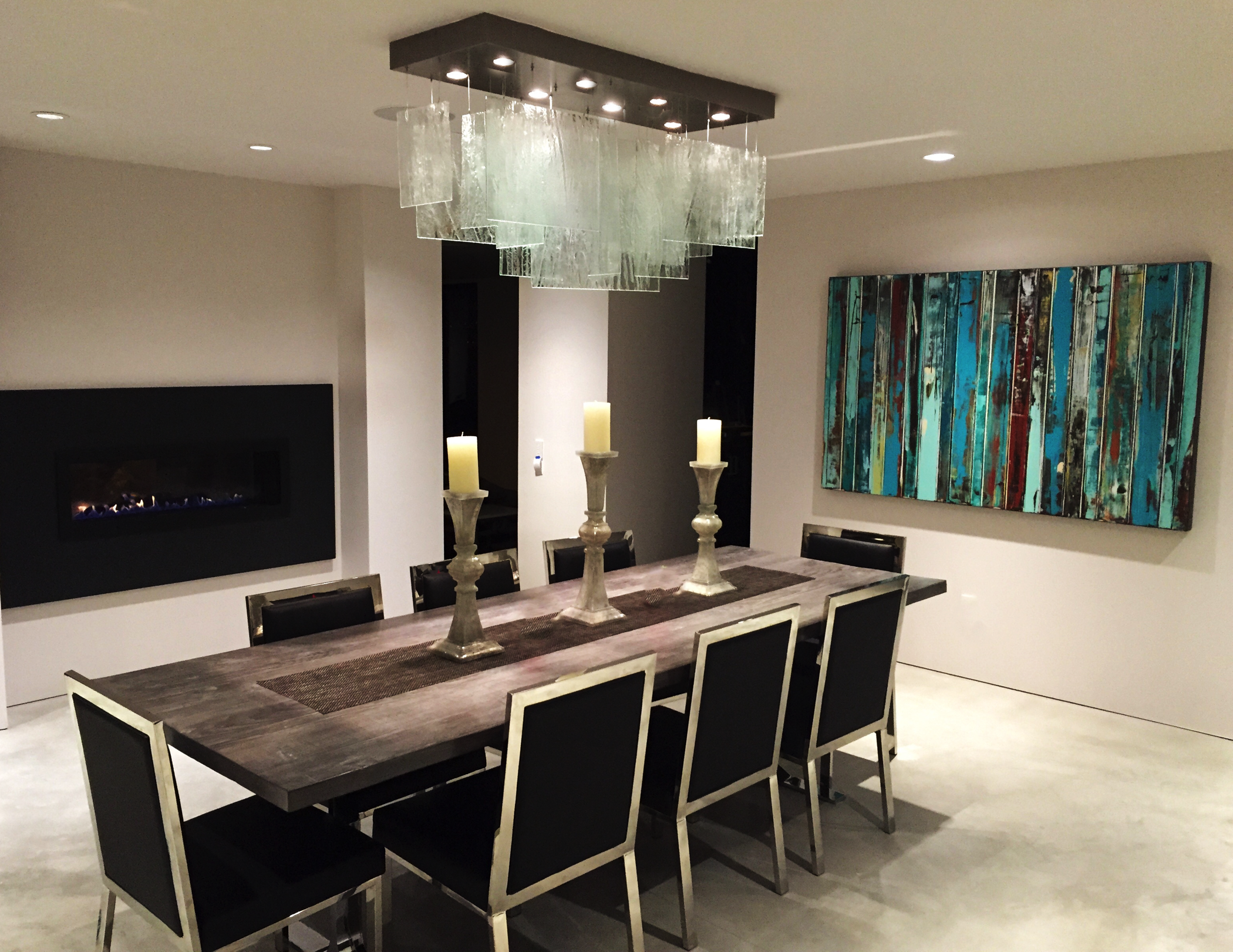 Layered translucent art glass creates a refined architectural statement above the dining table - a tailored lighting composition that can be adapted in size, proportions, glass finish and layout to suit the project.