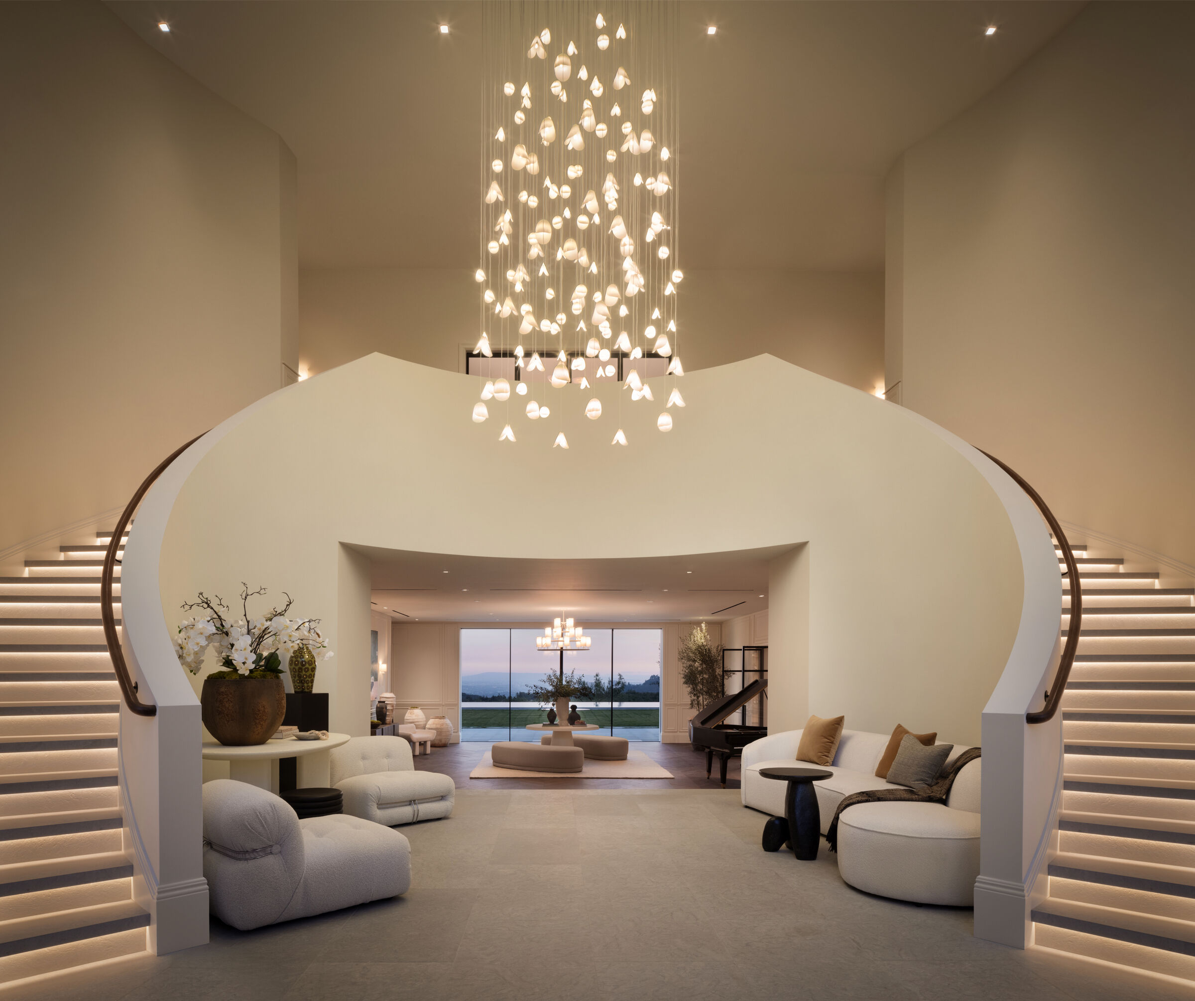 A cascading Bivalvia chandelier transforms the grand entry into a sculptural focal point.
