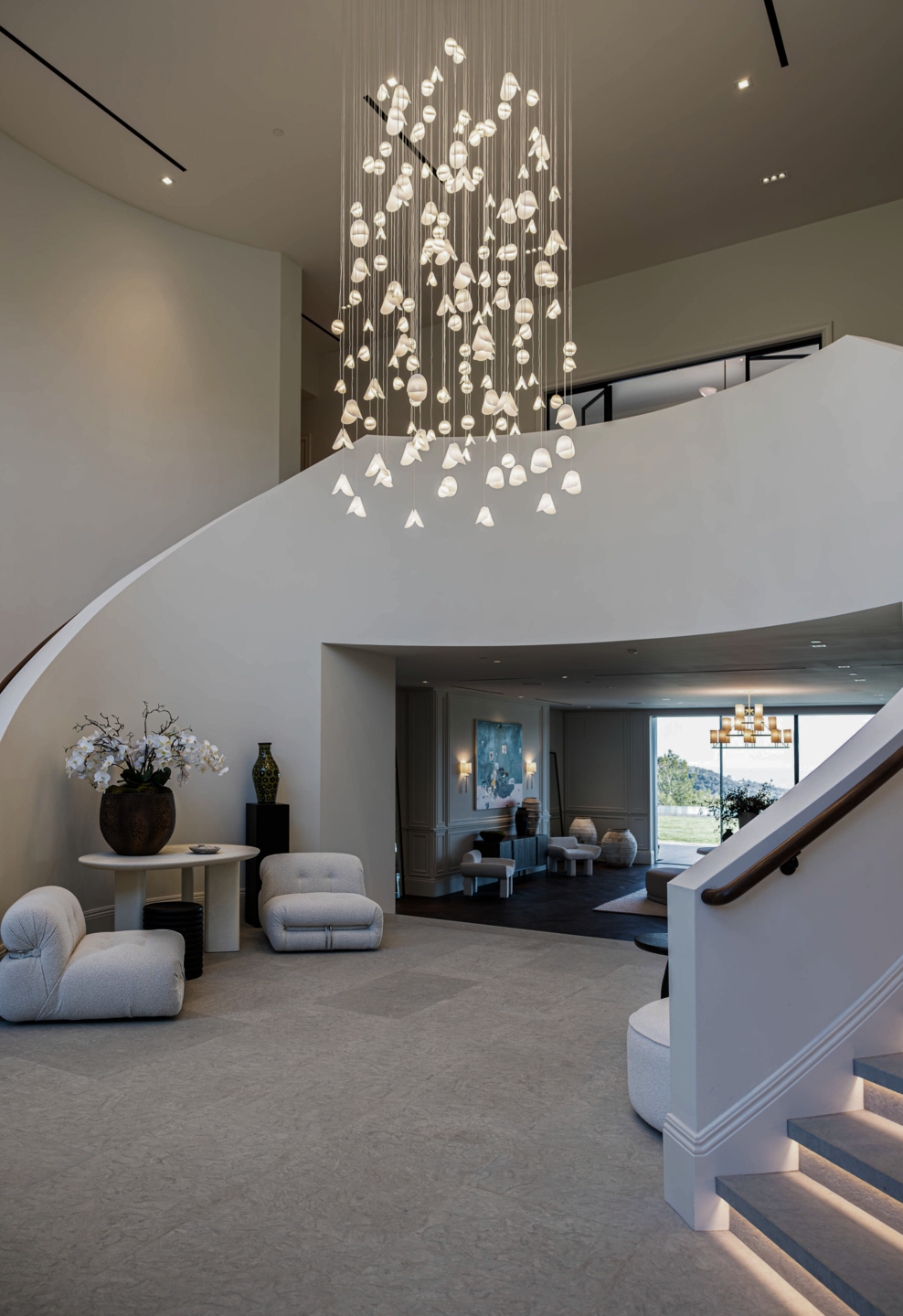 150 handcrafted glass pendants create a dramatic 13-foot composition for the double-height entrance.