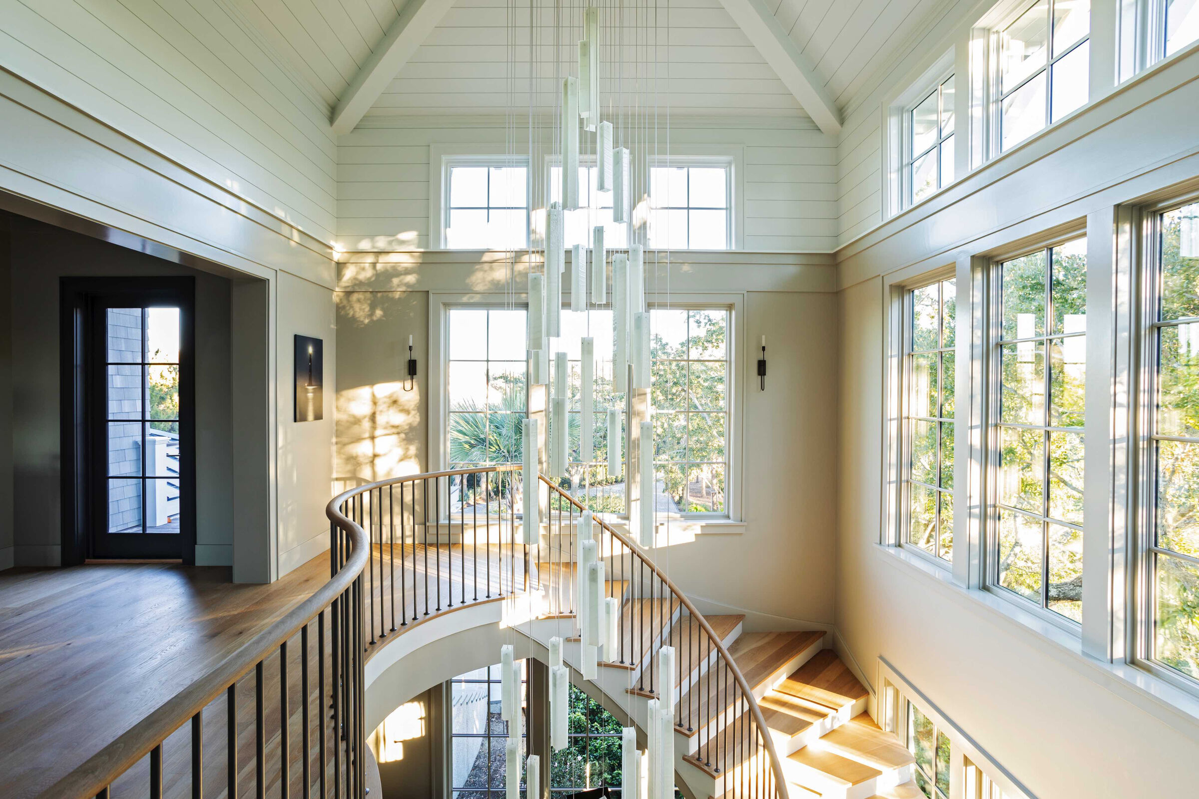 Designed around the architecture, the chandelier becomes a sculptural centerpiece visible from both levels of the home.