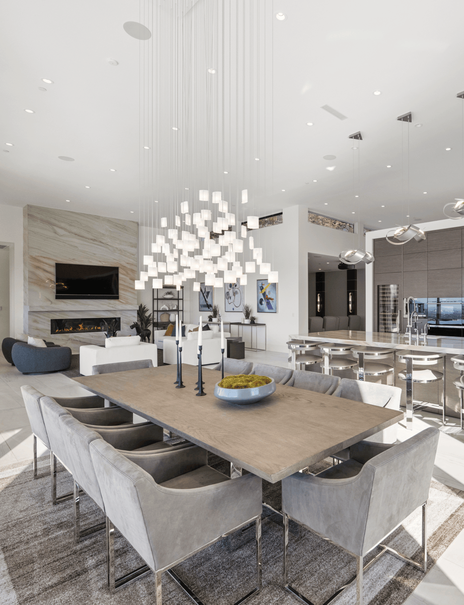 Multiple lighting installations connect the open living spaces through a unified artistic vision.