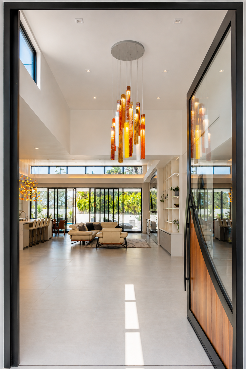 Bivalvia and Sunbeam chandeliers create a cohesive lighting language across the open-plan interior.