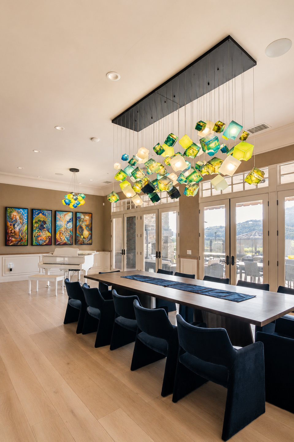 The colorful Noya chandelier complements the homeowner's art collection and open dining space.