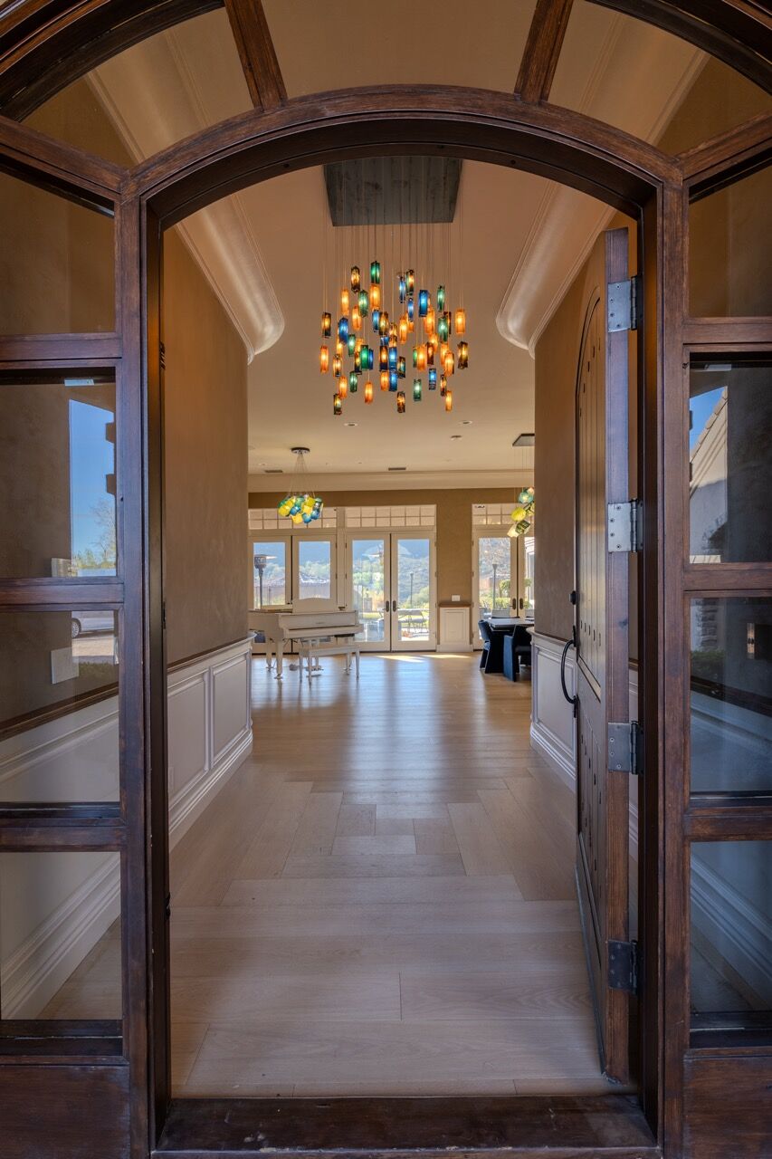 View through the entrance revealing the custom glass lighting installations throughout the home.