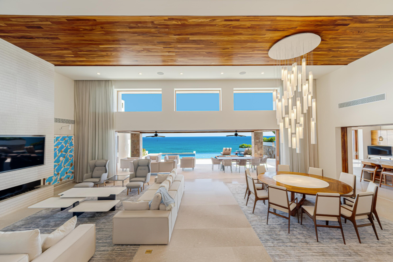 Custom glass lighting creates a sculptural focal point in the open-plan living and dining space of Villa Marselina.